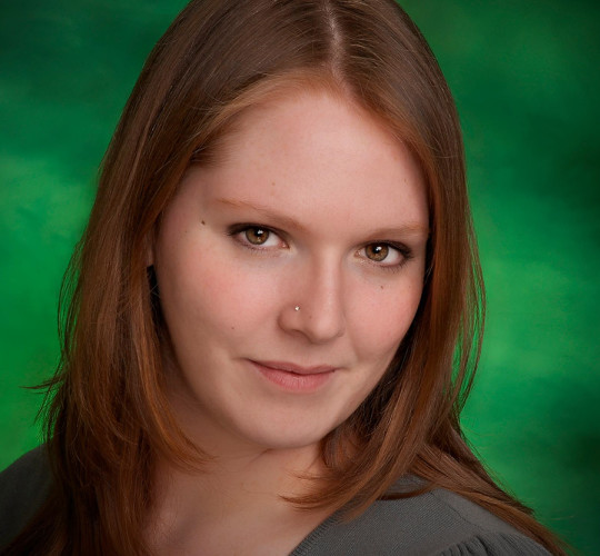 A girl smiling with green background