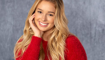 A girl smiling wearing a red sweater